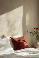 Soft sunlight casts shadows on a cozy bed with decorative pillows and floral accents in a serene room photo