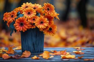 Bright orange flowers in a rustic pot surrounded by autumn leaves on a wooden table photo