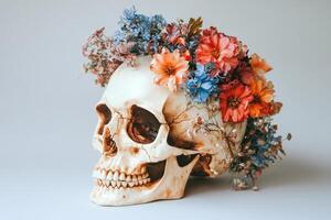 Floral arrangement atop a decorative skull surrounded by soft pastel colors photo