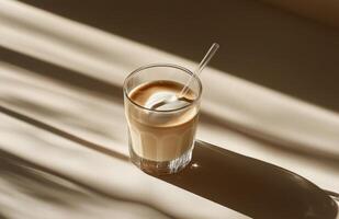 Warm golden beverage resting on a table with soft shadows during afternoon light photo