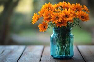 Bright orange flowers in a rustic pot surrounded by autumn leaves on a wooden table photo