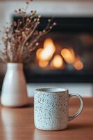 Cozy warm drink beside a glowing fireplace with dried flowers in soft background photo