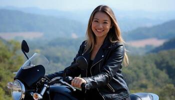A smiling Asian woman in a leather jacket rides a motorcycle on a scenic mountain road with lush greenery. photo