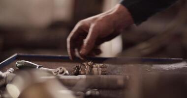 Crop technician arranging spar plugs on workbench video