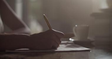 Focused female composer composing music in darkness with dim sunlight video