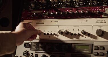 Man turning control knob on amplifier video