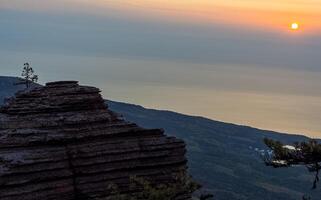 Mountains and forests of Crimea. coniferous and deciduous trees on the hills of mountains and rocks photo