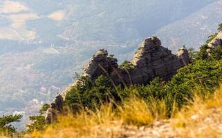 Mountains and forests of Crimea. coniferous and deciduous trees on the hills of mountains and rocks photo