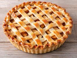 A pie with lattice on top of a wooden table photo
