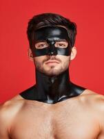 Man with black face and neck mask on red background photo