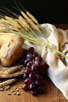 Assortment of freshly baked bread, grapes, and wheat stalks photo