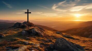 Dramatic sunset over a cross on a rocky mountain photo
