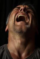 Intense facial expression of a man with an open mouth photo