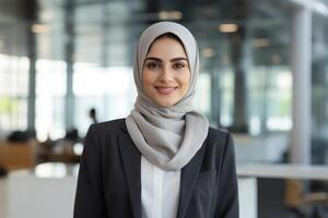 Smiling professional woman in business attire and hijab photo