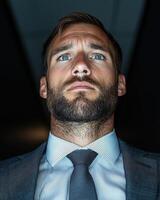 Confident businessman looking up, thinking about the future photo