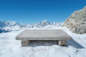 Empty wooden platform overlooking snowy mountain range photo