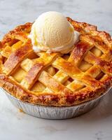 A delicious apple pie with a scoop of vanilla ice cream on top photo