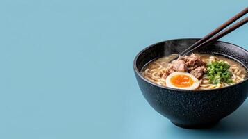 Steaming bowl of ramen noodles with pork, egg, and green onions photo
