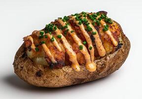 Loaded baked potato with chives and spicy mayo photo