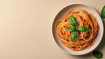 Overhead view of a plate of spaghetti with tomato sauce and basil photo