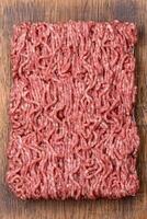 Fresh raw ground minced beef with salt and spices photo