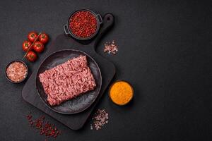 Fresh raw ground minced beef with salt and spices photo