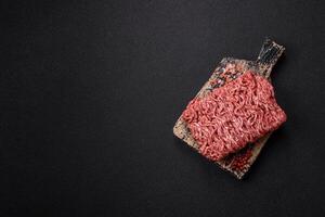 Fresh raw ground minced beef with salt and spices photo