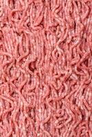 Fresh raw ground minced beef with salt and spices photo