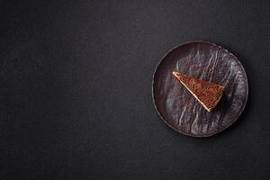 Slice of sweet cheesecake sprinkled with chopped chocolate photo