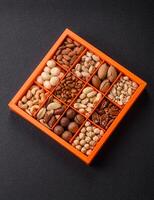 Box with various nuts cashew, macadamia, peanut, cedar, pecan, walnut, brazil, hazelnut photo