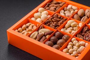 Box with various nuts cashew, macadamia, peanut, cedar, pecan, walnut, brazil, hazelnut photo