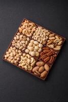 Box with various nuts cashew, macadamia, peanut, cedar, pecan, walnut, brazil, hazelnut photo