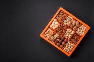 Box with various nuts cashew, macadamia, peanut, cedar, pecan, walnut, brazil, hazelnut photo
