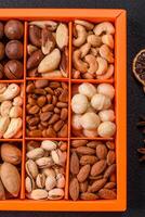 Box with various nuts cashew, macadamia, peanut, cedar, pecan, walnut, brazil, hazelnut photo