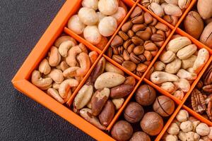 Box with various nuts cashew, macadamia, peanut, cedar, pecan, walnut, brazil, hazelnut photo