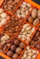Box with various nuts cashew, macadamia, peanut, cedar, pecan, walnut, brazil, hazelnut photo