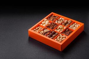 Box with various nuts cashew, macadamia, peanut, cedar, pecan, walnut, brazil, hazelnut photo