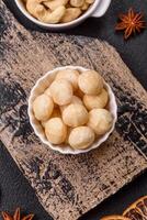 Delicious nutritious macadamia nuts in ceramic bowl photo