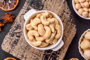 Delicious nutritious cashew nuts in ceramic bowl photo