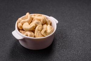Delicious nutritious cashew nuts in ceramic bowl photo