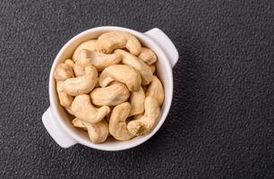 Delicious nutritious cashew nuts in ceramic bowl photo