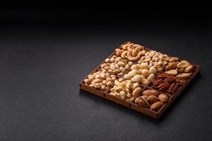 Box with various nuts cashew, macadamia, peanut, cedar, pecan, walnut, brazil, hazelnut photo
