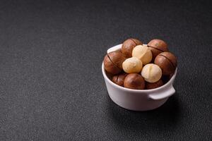 Delicious nutritious macadamia nuts in ceramic bowl photo