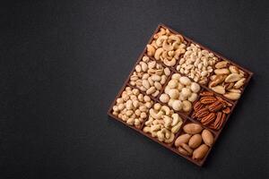 Box with various nuts cashew, macadamia, peanut, cedar, pecan, walnut, brazil, hazelnut photo