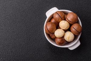 Delicious nutritious macadamia nuts in ceramic bowl photo