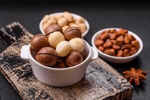 Delicious nutritious macadamia nuts in ceramic bowl photo