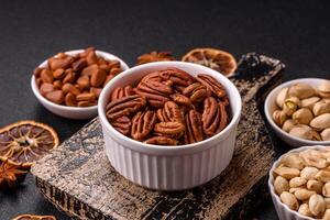 Delicious nutritious pecan nuts in ceramic bowl photo