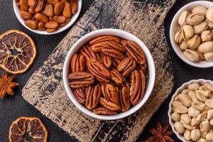 Delicious nutritious pecan nuts in ceramic bowl photo