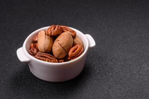 Delicious nutritious pecan nuts in ceramic bowl photo