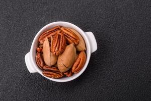 Delicious nutritious pecan nuts in ceramic bowl photo